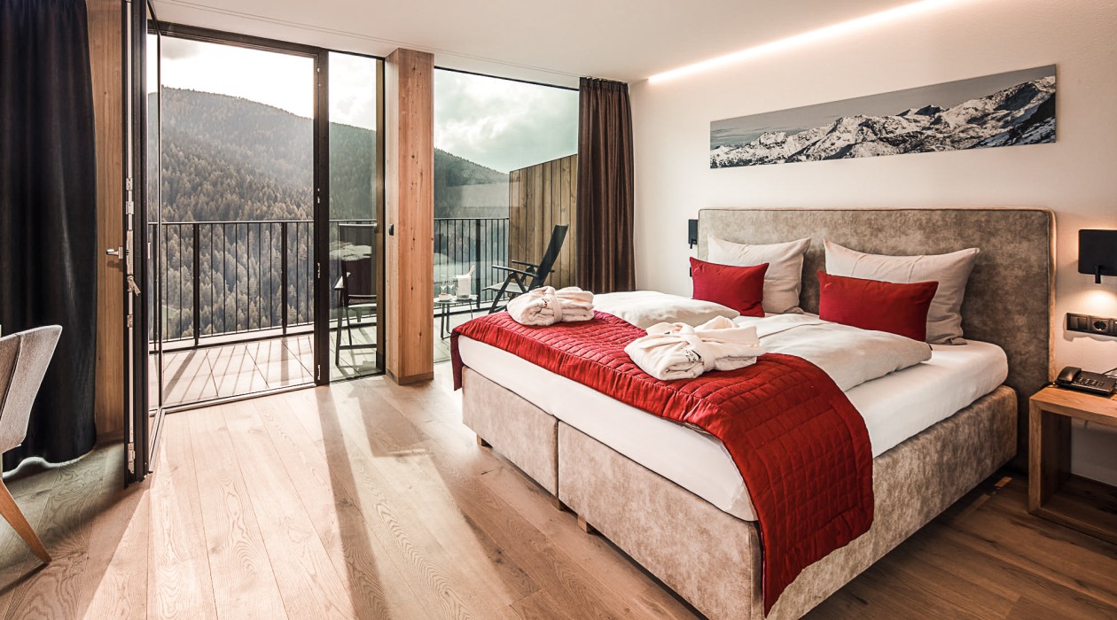 Modern double room at Hotel Panoramic Lotsch with panoramic view over the quiet Sarntal valley – perfect for active guests in South Tyrol.