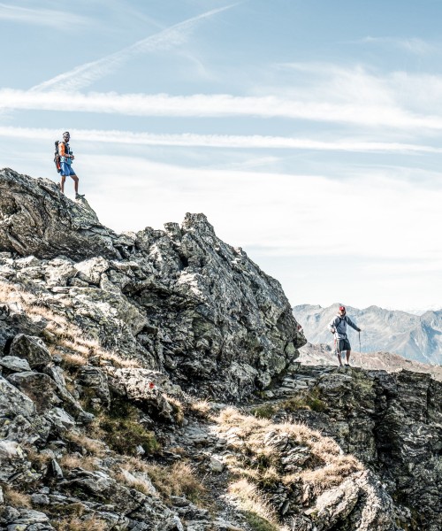 Wandern mit Aussicht – aktiv im Sarntal unterwegs Zwei Wanderer auf felsigem Höhenweg im Sarntal – aktives Naturerlebnis mit Weitblick in Südtirol